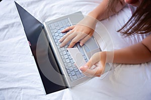 Young woman holding credit card and using laptop computer for shopping online at home.Online shopping, e-commerce