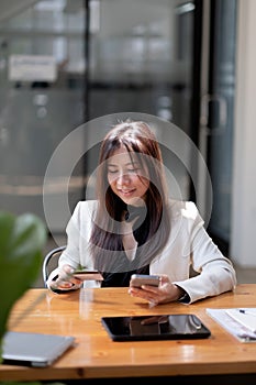 Young woman holding credit card and using smart phone for online shopping. Online payment shopping concept. copyspace