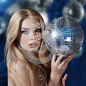 Young woman holding disco ball