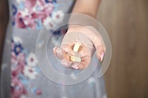 Young woman holding drug