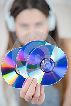 Young woman holding dvd-rom or cds