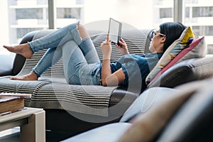 Young Woman Holding Ereader And Reading Ebook