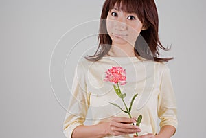 Young woman holding flower