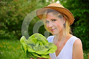 Young woman holding fresh lettuce - gardening