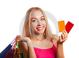 Young woman holding gift cards and shopping bags