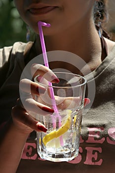 Young woman holding a glass of lemonade
