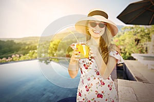 Young woman holding a glass of orange juice