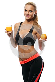 Young woman holding glass of orange juice and