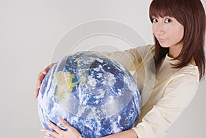 Young woman holding globe