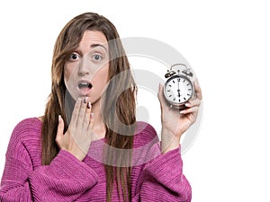 Young woman holding a hand to her mouth, and holding a watch at six o clock