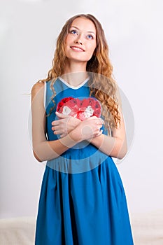 Young woman holding heart shaped box