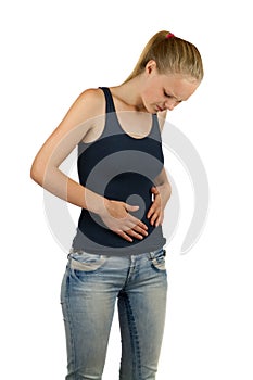 Young woman is holding her belly in pain photo