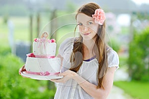 Young woman holding her birthday cake