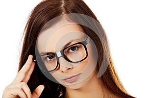 Young woman holding her glasses