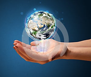 Woman holding a glowing earth globe