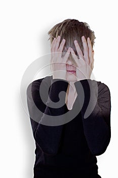 Young woman holding her hands over her face photo