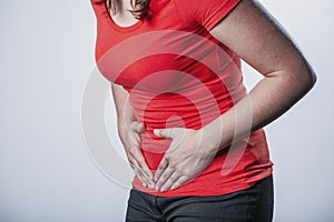 Woman holding her tummy and suffering from menstrual cramps photo