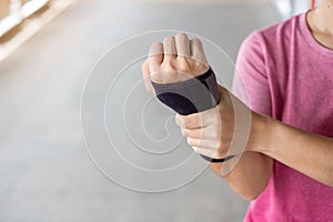 Young woman holding her wrist pain because using computer long time. De Quervain`s tenosynovitis, Intersection Symptom, Carpal