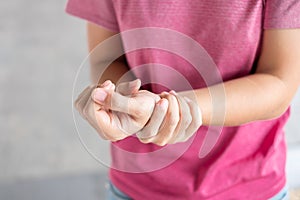 Young woman holding her wrist pain because using computer long time. De Quervain`s tenosynovitis, Intersection Symptom, Carpal