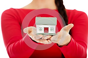 Young woman holding house model