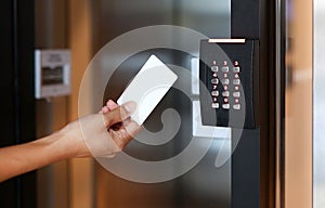 Young woman holding a key card to lock and unlock door.