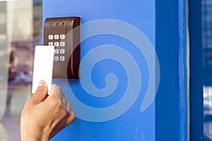 Young woman holding a key card to lock and unlock door.,