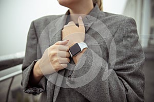 Young woman holding lapels of her jacket