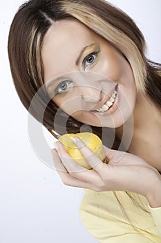 Young woman holding a lemon