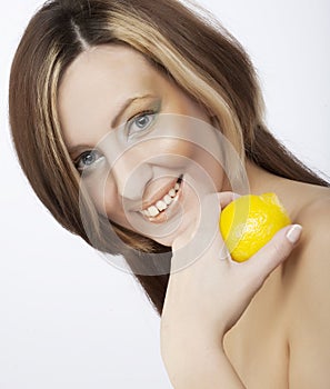 Young woman holding a lemon