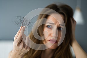 Young Woman Holding Loss Hair