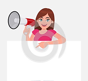 Young woman holding a megaphone or loudspeaker in hand. Girl showing or pointing blank white poster or banner for copy space text.