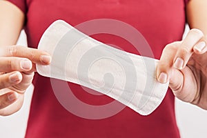 Young woman holding mentrual pad