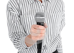 Young woman holding microphone on white background