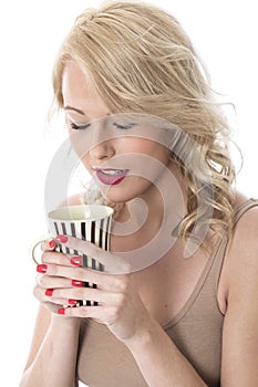 Young Woman Holding Mug of Coffee with Both Hands Looking into Mug