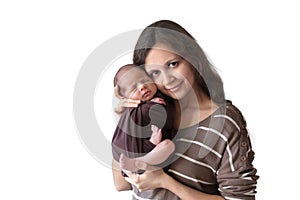 Young woman holding a newborn baby in her arms on the white background. Newborn photosession. Family portrait