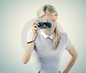 Young woman holding old film camera