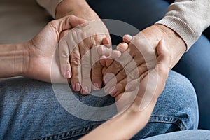 Young woman holding older mother hands, help and support