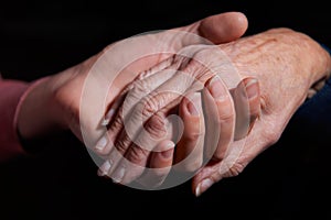 Young Woman Holding Older Woman's Hand