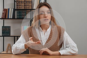 Young woman holding online webinar indoors, view from webcam