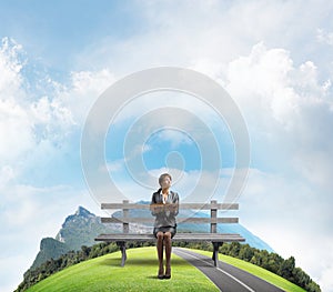 Young woman holding open book on wooden