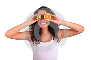Young woman holding orange and kiwi. Isolated over white