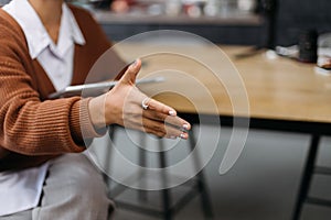 young woman holding out her hand for a handshake.