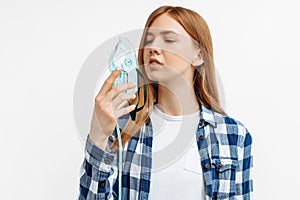 Young woman holding oxygen mask to treat breathing problem, Covid-19 attack lungs on white background
