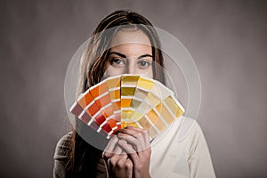 Young woman holding a pantone palette