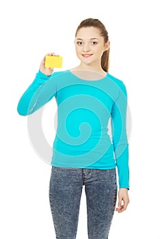 Young woman holding paper card.