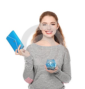 Young woman holding piggy bank and wallet on white background. Money savings concept