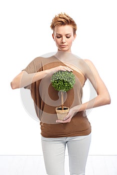 Young woman holding potted plant