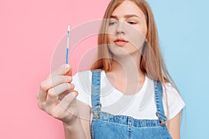 Young woman holding a pregnancy test