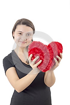 Young woman holding a red heart isoalated on white