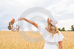 Young woman holding a shoe - sale, consumerism and people concept